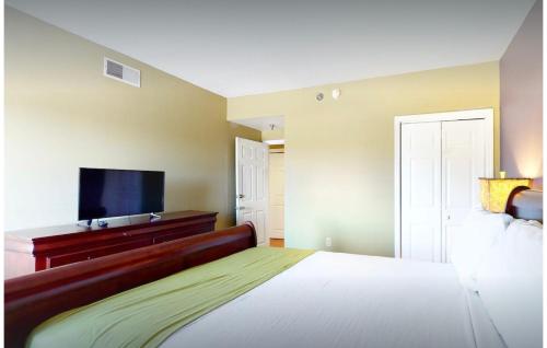a bedroom with a large bed and a flat screen tv at RRP Condo in Pigeon Forge