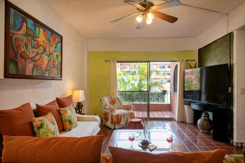 a living room with a couch and a tv at Departamento en Marina Vallarta New listing in Puerto Vallarta
