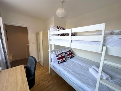 a room with two bunk beds and a table at Euston flat in London