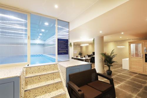 a waiting room with a chair and a swimming pool at Gapyeong Grache Hotel in Gapyeong