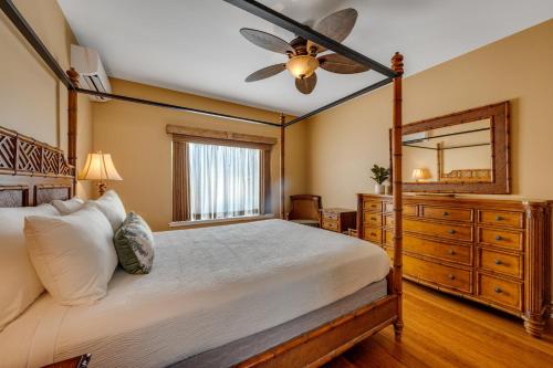 a bedroom with a bed and a ceiling fan at Tropical Oasis at Regency at Poipu Kai 514 in Koloa