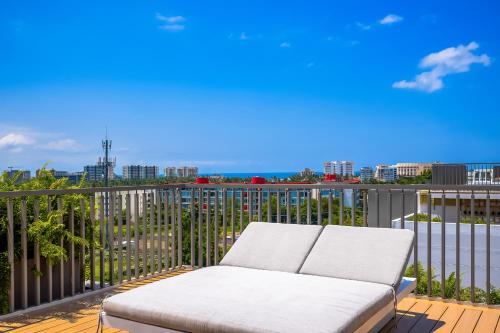 a couch on a balcony with a view of a city at Punto Novo 504 in Nuevo Vallarta 