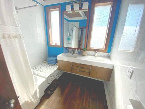 a bathroom with a tub and a sink and a mirror at The Coman's beach house in Hoodsport