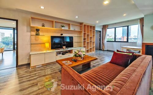 a living room with a couch and a tv at W8 Condo, LUXE 2 Bedroom Private floor, Best Hip Central Bangkok area, 5 mins from Thonglo BTS station in Bangkok