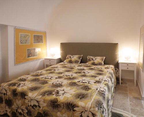 a bedroom with a bed and two night stands at B&B Relais Del Senatore in Polignano a Mare