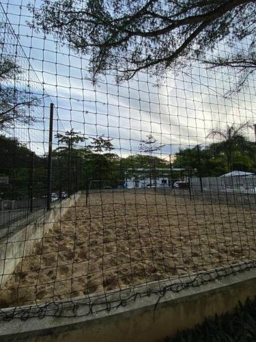 a fence with a baseball field in the background at ApartaSol san Jerónimo in San Jerónimo