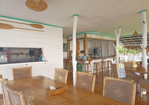 a dining room with a table and chairs at Katiet Beach Resort Mentawai Lances Right HTS in Katiet