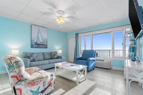 a living room with a couch and chairs and a table at Slice o’ Paradise - Gulf Front! Walk to Pier Park in Panama City Beach