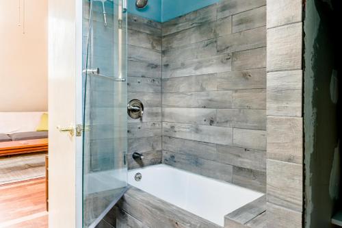 a bathroom with a shower with a tub at Portland Urban Lodge, Quiet, Walkable, Near in Portland