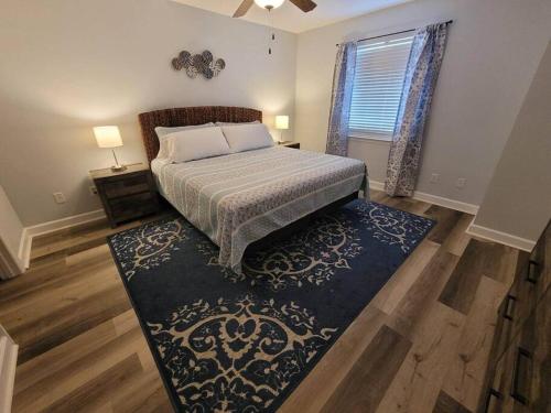 a bedroom with a bed and a large rug at McDrifty's Getaway in Panama City Beach