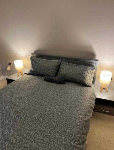 a bedroom with a large bed with two lamps at Modern Room with Private Bathroom in Croydon