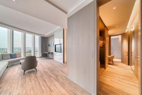 a living room with a couch and a chair at Courtyard by Marriott Hangzhou Xihu in Hangzhou