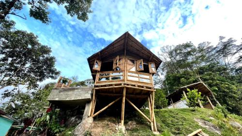 a tree house sitting on top of a hill at Hostería El Sendero - Cocorná in Cocorná
