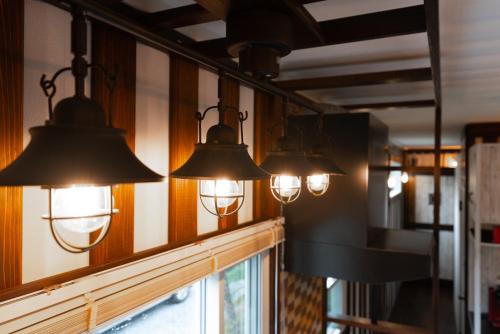 a group of lights on a wall next to a mirror at Vacation Village Okinawa - Nakijin in Nakijin