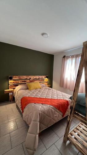 a bedroom with a large bed in a room at Las Cabañitas dp2 in San Carlos de Bariloche