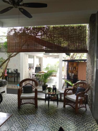 a room with chairs and a table and a patio at Villa Papillon in Phnom Penh