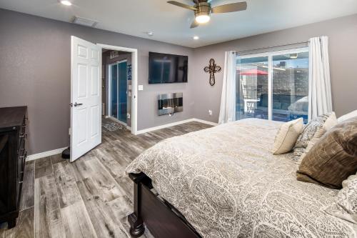 a bedroom with a bed and a window at Coral Beauty! Heated Pool & Spa! in Lake Havasu City