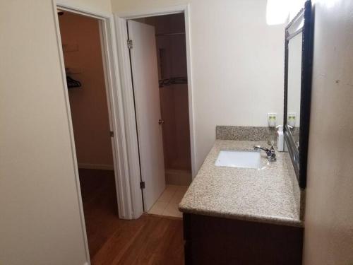 a bathroom with a sink and a mirror at Beautiful Spacious 2 Bedroom, 2 Bathroom Condo in Long Beach