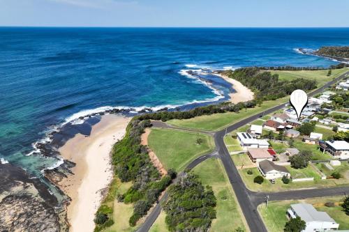 an aerial view of a beach with a hot air balloon at Seaside Escape in Burrill Lake
