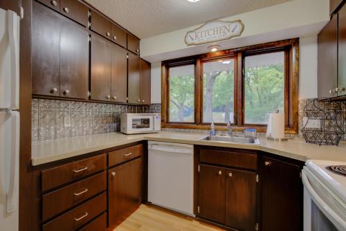 a kitchen with wooden cabinets and a white appliance at The Greenwood in Manhattan