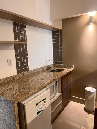a kitchen with a sink and a counter top at Olímpia Park Resort - Apto 2 Quartos 8 Pessoas in Olímpia