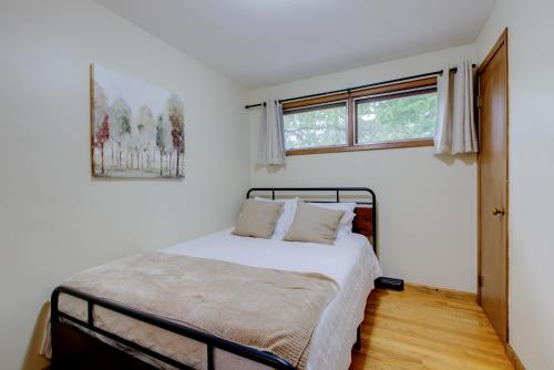 a bedroom with a bed and two windows at The Greenwood in Manhattan