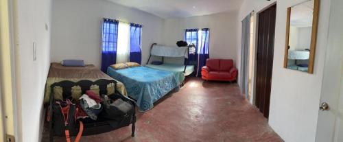 una camera con letto e sedia rossa di Amalia's House a Los Manaderos