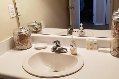 a bathroom counter with a sink and a mirror at McDrifty's Hideaway in Panama City Beach