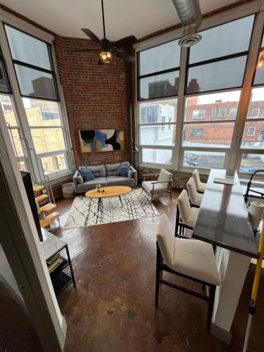 a living room with large windows and a couch at Exceptional 1 Br Apartment Downtown W Study Loft in Roanoke