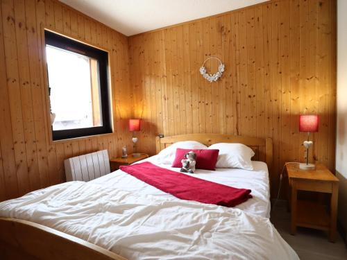 a bedroom with a bed with a teddy bear sitting on it at Les Gets - Appart cosy avec mezzanine et parking, proche pistes - FR-1-623-145 in Les Gets