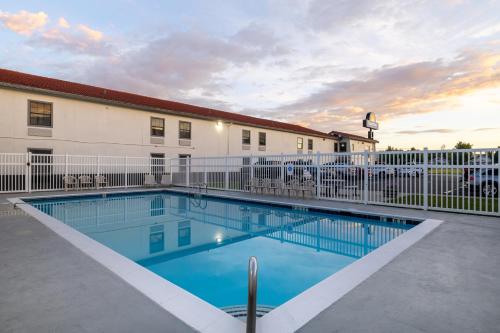 a swimming pool in front of a building at Days Inn by Wyndham Casper in Casper