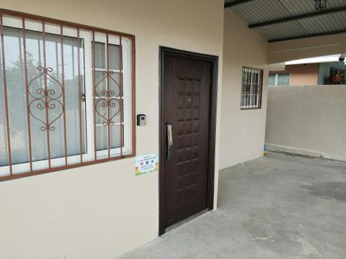 a wooden door in a building with a garage at La Casa Buena Esperanza in Penonomé