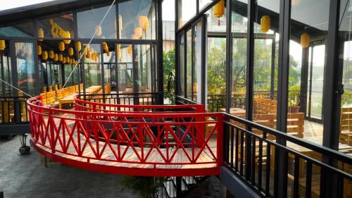 a red basket on a balcony of a building at Sunny Garden Riverside Hotel Ninh Binh in Ninh Binh