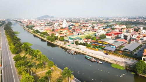 an aerial view of a city with a river at Sunny Garden Riverside Hotel Ninh Binh in Ninh Binh