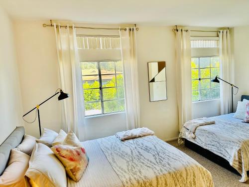 洛杉磯的住宿－The Clouds，一间卧室设有两张床和两个窗户。