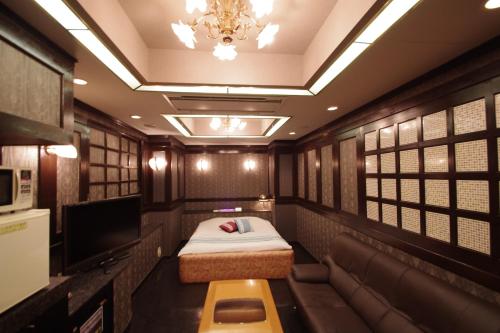 a train room with a bed and a tv at Hotel PRINCESS2 大人専用 in Tokyo