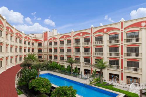 a large building with a pool in front of it at WYNDHAM Foshan shunde in Shunde