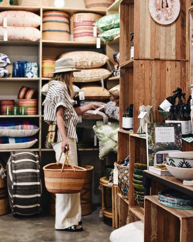 a woman standing in a store holding a basket at Seahaven Village in Barwon Heads