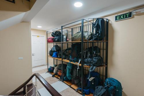 a room with a rack full ofpacks and backpacks at Cheers Hostel Hanoi in Hanoi
