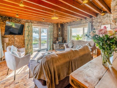 a living room with a couch and a table at Bwlch Farm Lodge in Briton Ferry