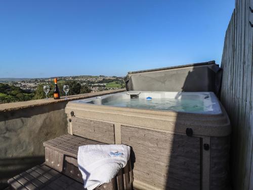 a hot tub sitting on the side of a building at The Old Piggery in Keighley
