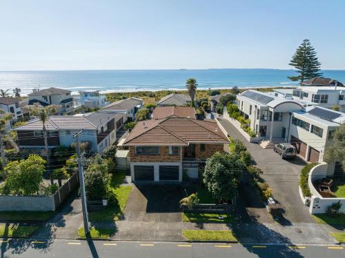 an aerial view of houses and the beach at Magnificent sunrises, Oceanbeach & Sea Views in Tauranga