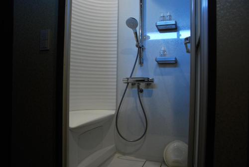 a bathroom with a shower next to a toilet at 金沢一棟宿 海泉 Restoring In Kanazawa KAISEN in Kanazawa