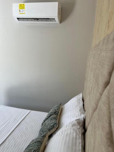 a bedroom with a bed with a heater on the wall at HOTEl LA CANDELARIA ROOM HOUSE in Mangue