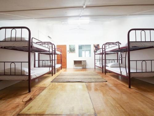 a room with four bunk beds in it at Amida Point in Kuching