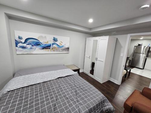 a bedroom with a bed and a refrigerator at Exclusive 2 BR Furnished Apartment in Milton Ontario Canada in Milton