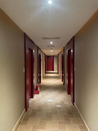 a hallway with red doors and a long corridor at Kenting Southern Dream Resort in Kenting