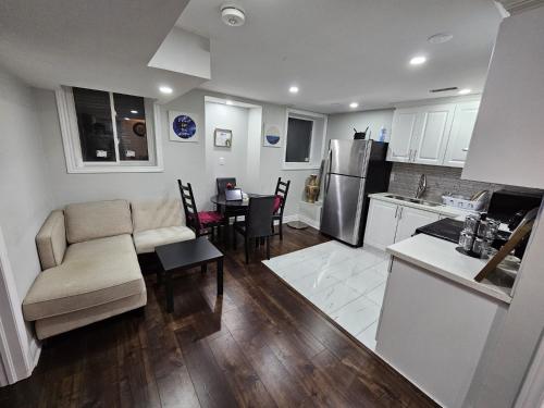 a kitchen and living room with a couch and a table at Exclusive 2 BR Furnished Apartment in Milton Ontario Canada in Milton