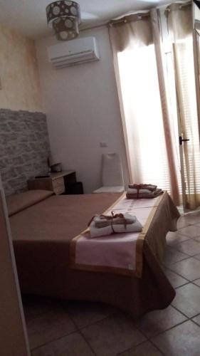 a bedroom with two beds with towels on them at B&B Dimora del centro in Scalea