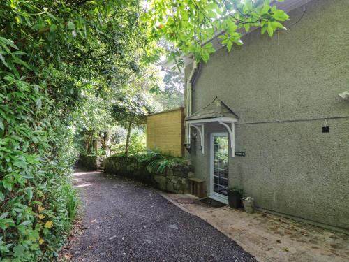 a house with a driveway next to a building at Chydour in Penzance